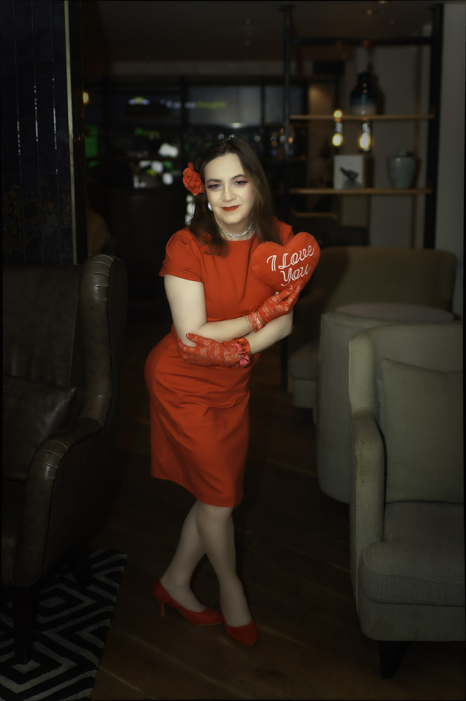 Annabelle standing in a red dress at the hotel, getting ready for the evening