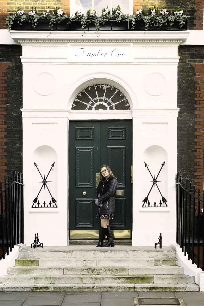 Annabelle in a black coat and knee-high black boots in Covent Garden, London