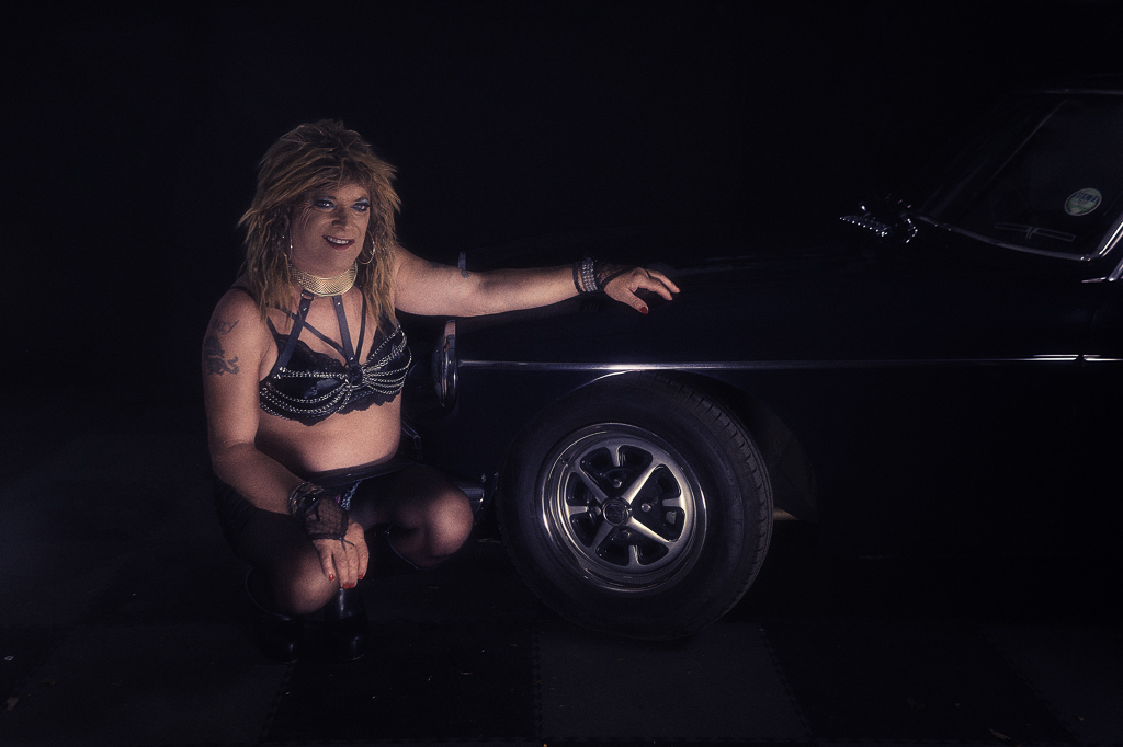 Cheryl posing with MGB classic car