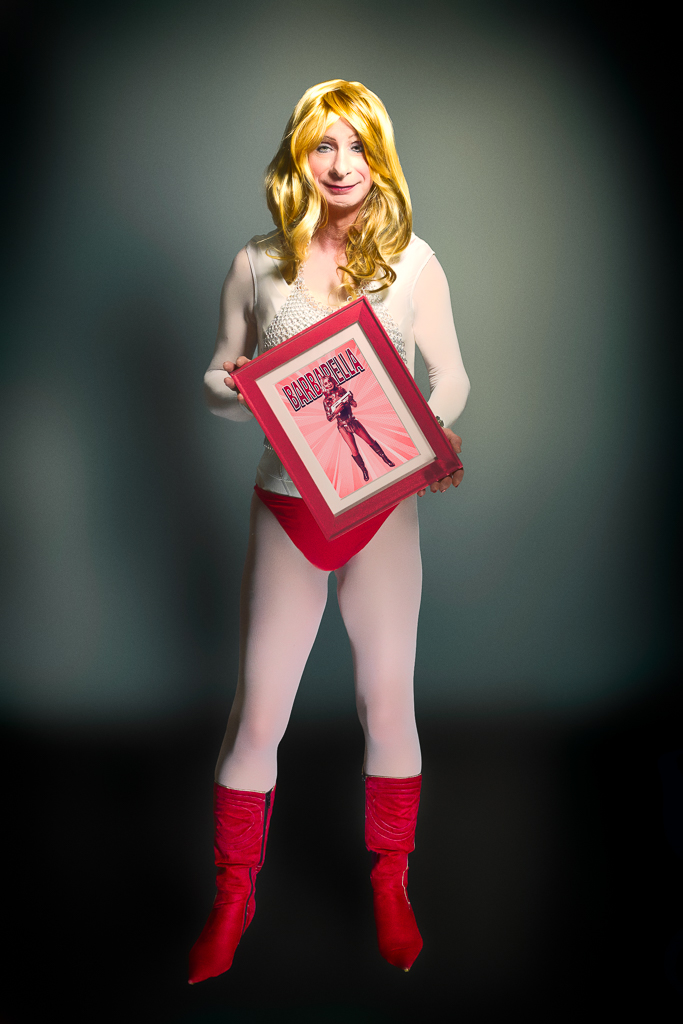 Rachel Anya as Barbarella holding a photo of herself as Barbarella