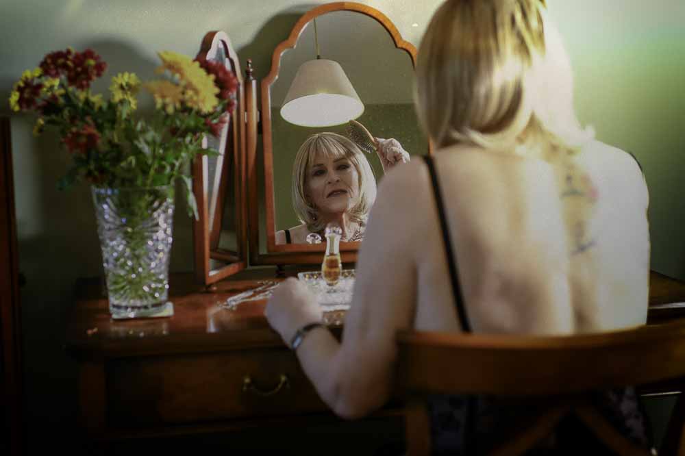 Stella at dressing table looking in mirror