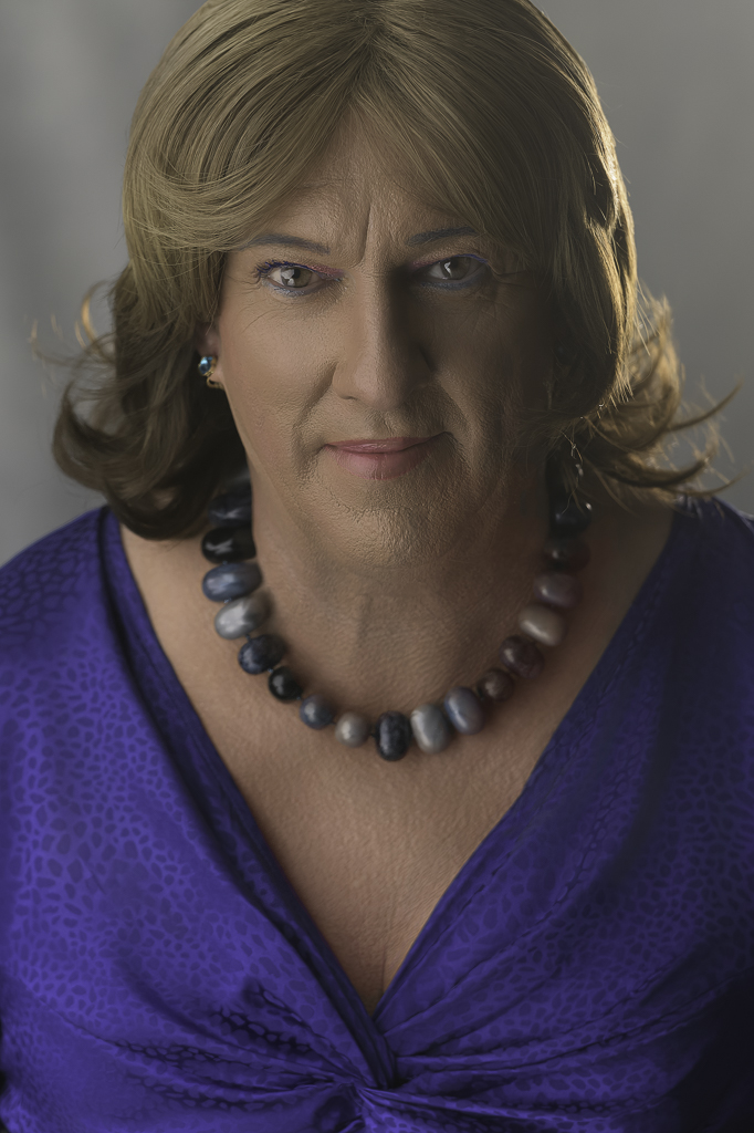 Headshot shot of Tracie in blue dress