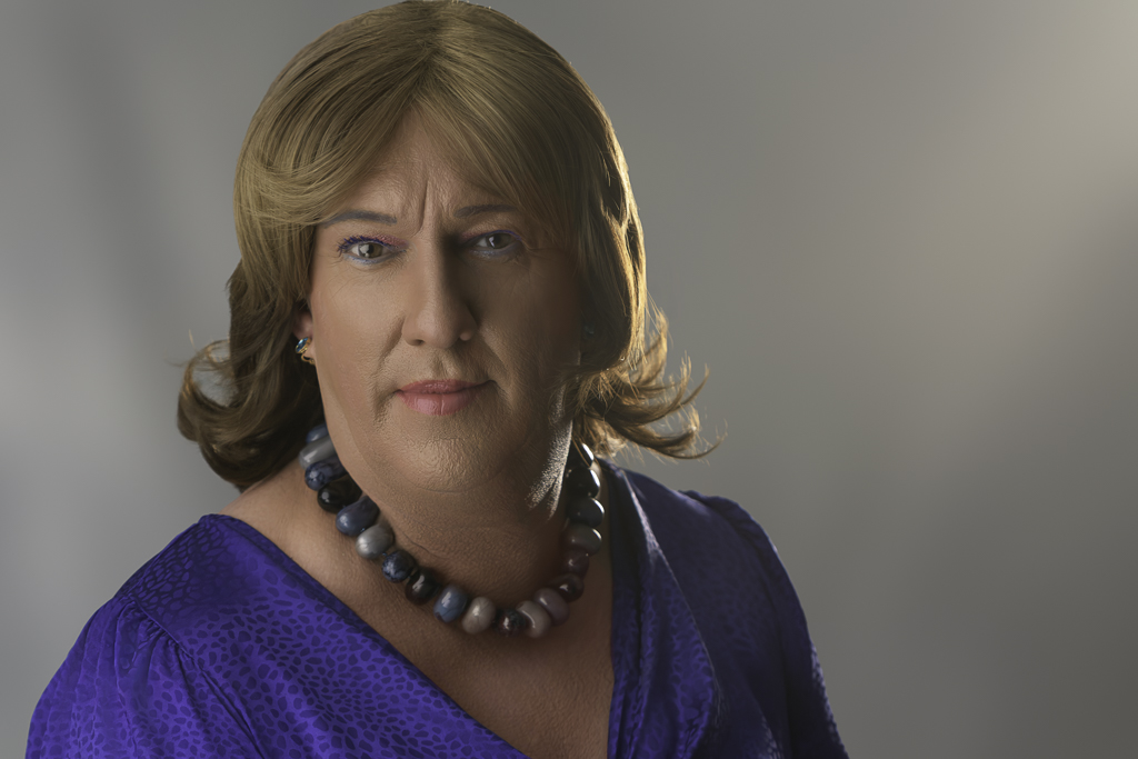 Headshot shot of Tracie in blue dress