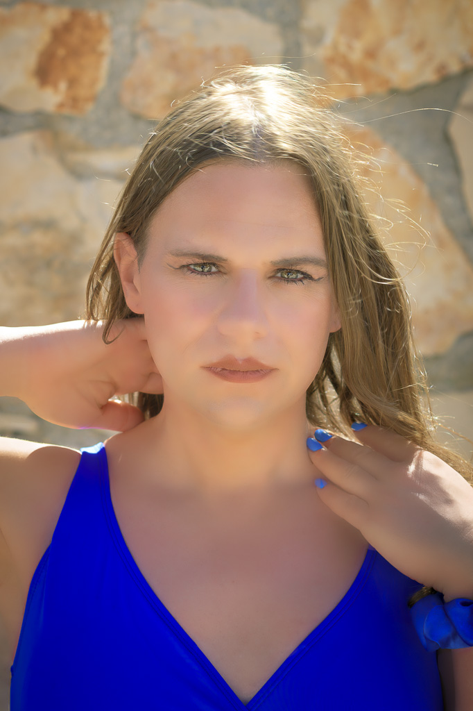 Jessica in a blue swimsuit against a cream coloured wall, Zakynthos