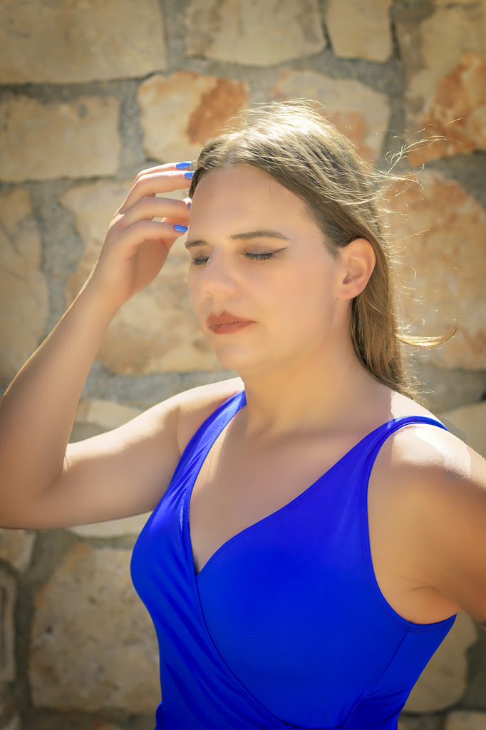Jessica in a blue swimsuit against a cream coloured wall, Zakynthos