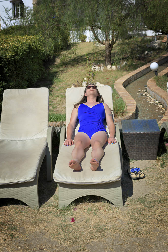 Jessica in a blue swimsuit on a sunbed, Zakynthos