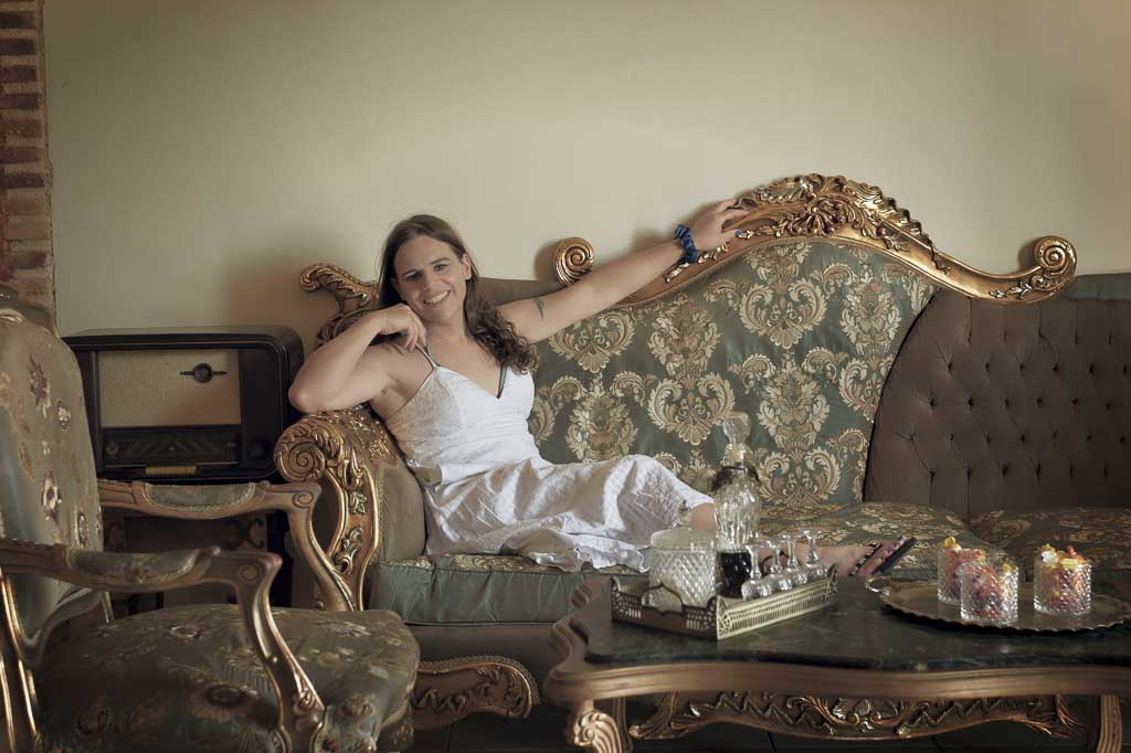 Jessica in a white sun dress in the hotel foyer, which has a Greek retro feel, Zakynthos