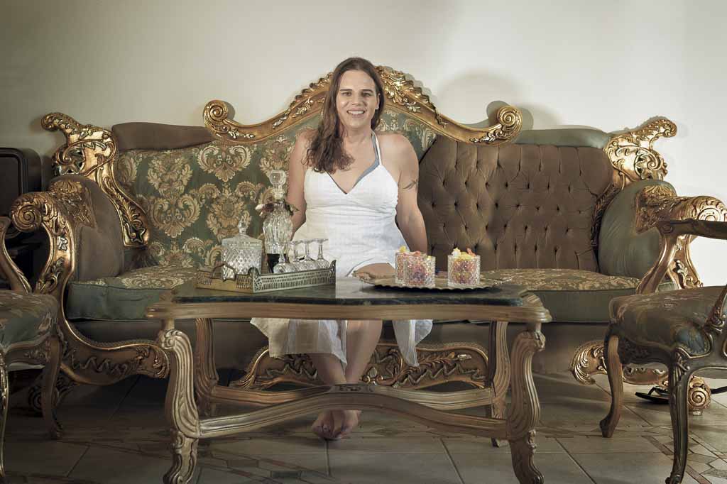 Jessica in a white sun dress in the hotel foyer, which has a Greek retro feel, Zakynthos