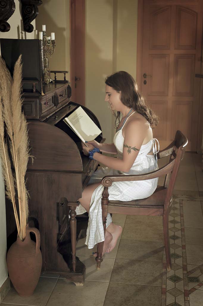 Jessica in a white sun dress in the hotel foyer, which has a Greek retro feel, Zakynthos