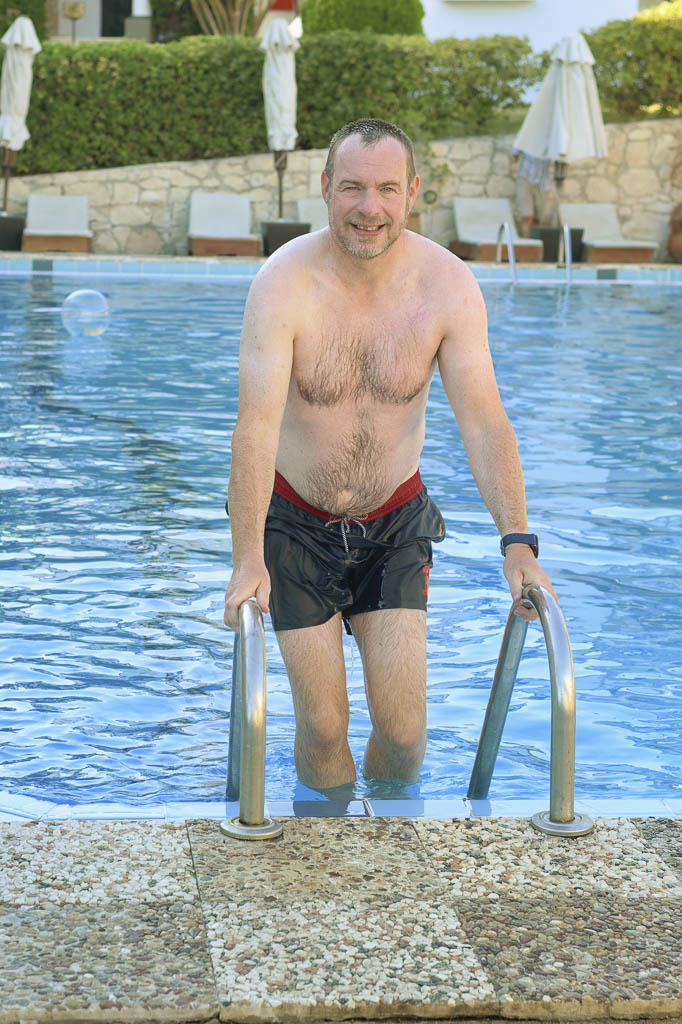 Richard in blue swim trunks, climbing out of the pool, Zakynthos