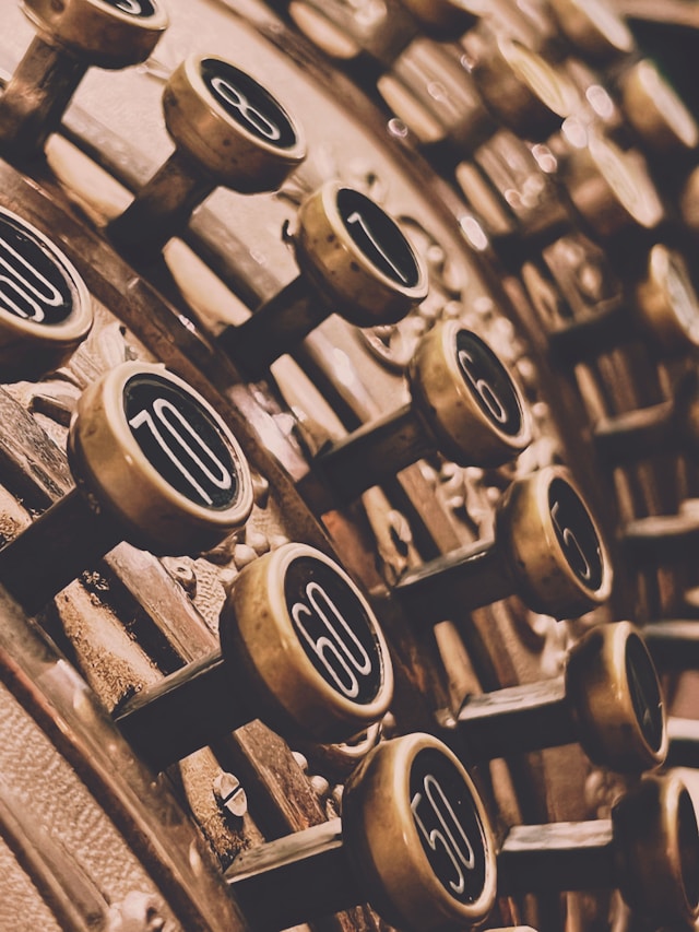 A close up picture of an old-fashioned cash till with sephia filter