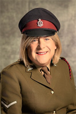 Smiling model in a khaki military-style uniform and peaked cap